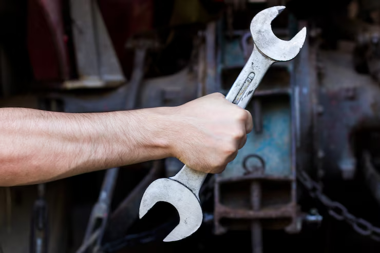 hand-holding-wrench-dark-background_1212-887 hand-holding-wrench-dark-background_1212-887