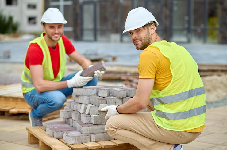 two-workers-stacking-bricks-looking-camera_259150-57659 two-workers-stacking-bricks-looking-camera_259150-57659